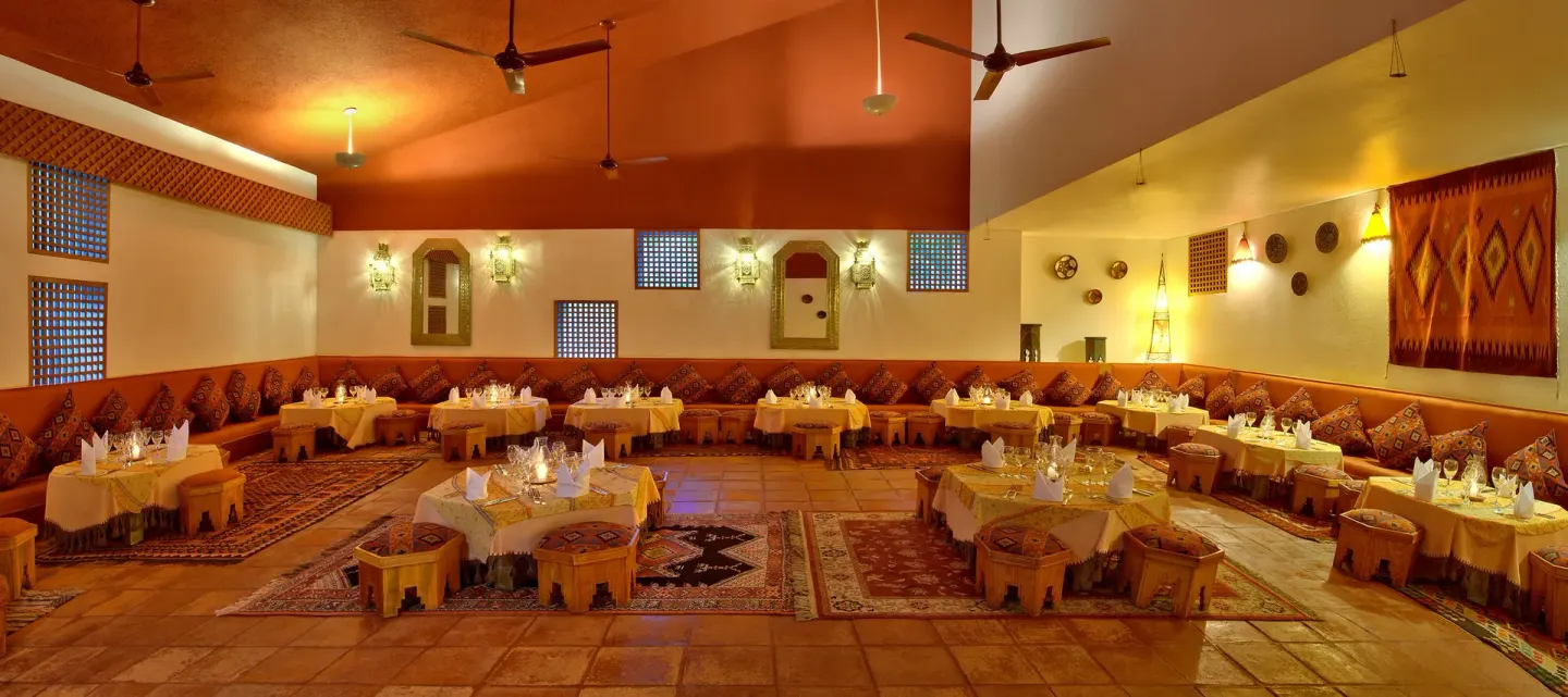 Middle Eastern dining room with low seating and patterned cushions at Las Brisas Huatulco.
