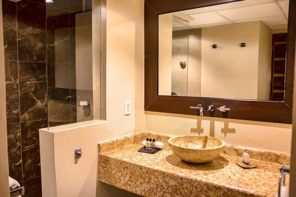 Deluxe Room bathroom vanity and glass shower at Las Brisas Huatulco.