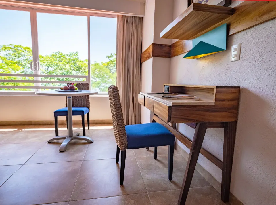 Deluxe Room desk and window table with leafy view at Las Brisas Huatulco.