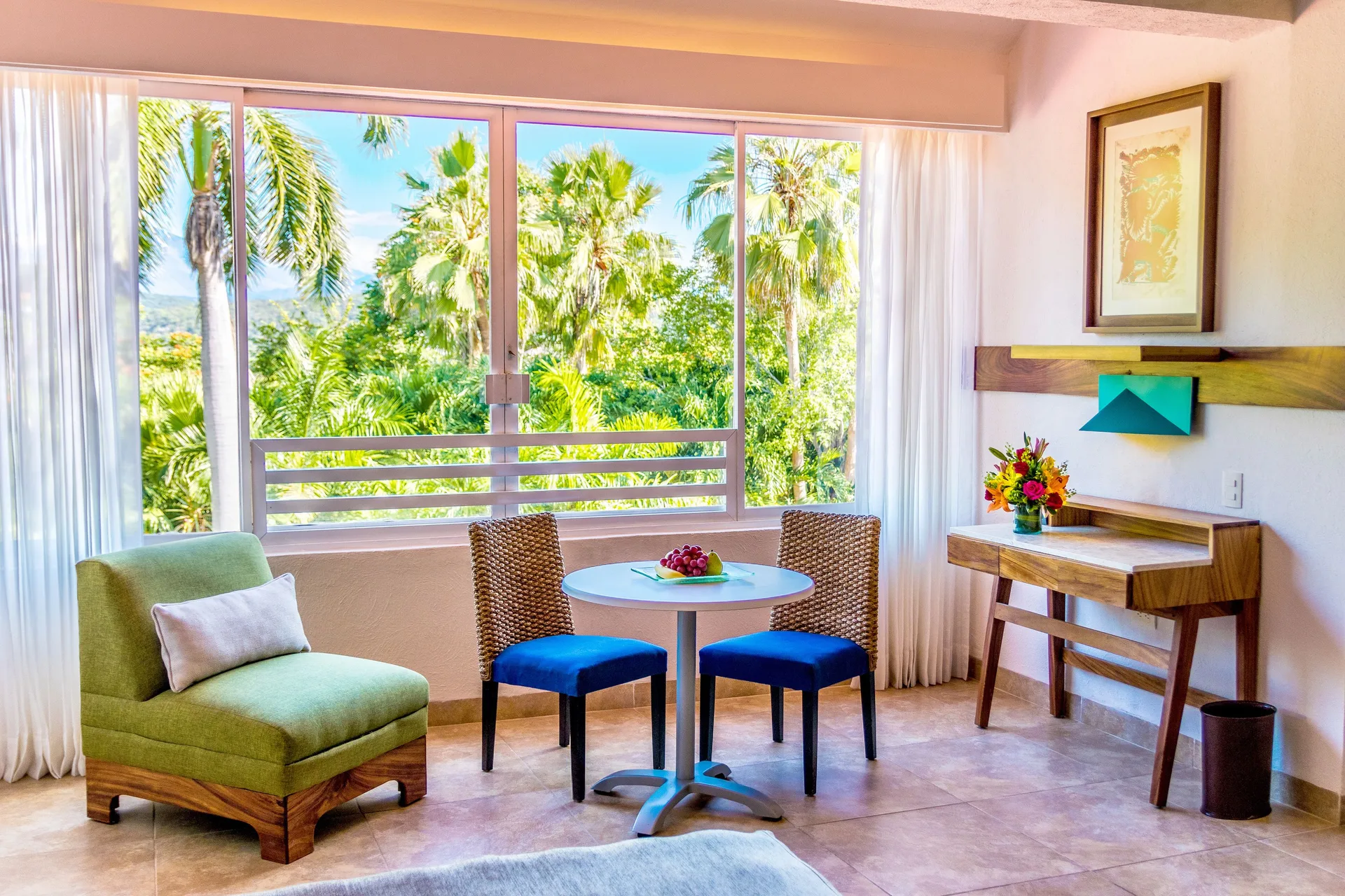 Deluxe Room sitting area with palm view at Las Brisas Huatulco.