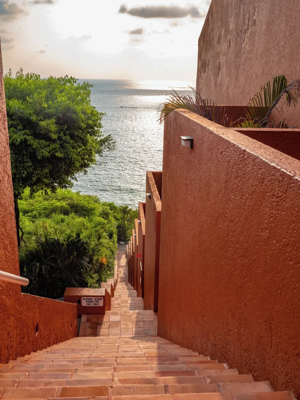 Terracotta stairway descending toward the ocean at Las Brisas Ixtapa.