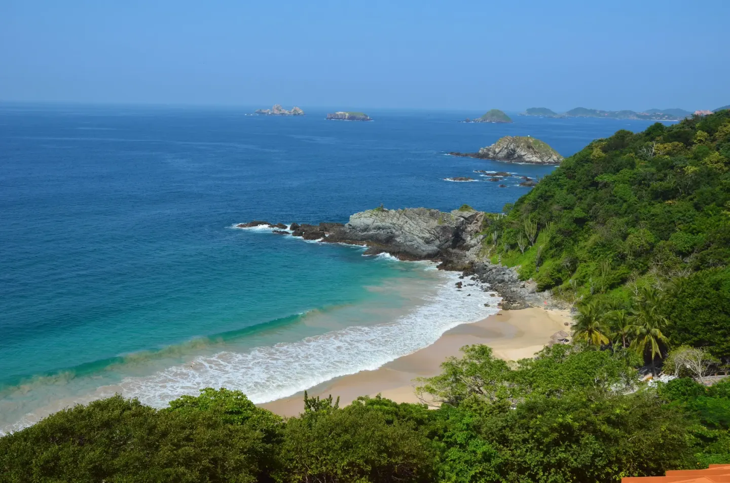 Rocky cove and turquoise Pacific water below Las Brisas Ixtapa.
