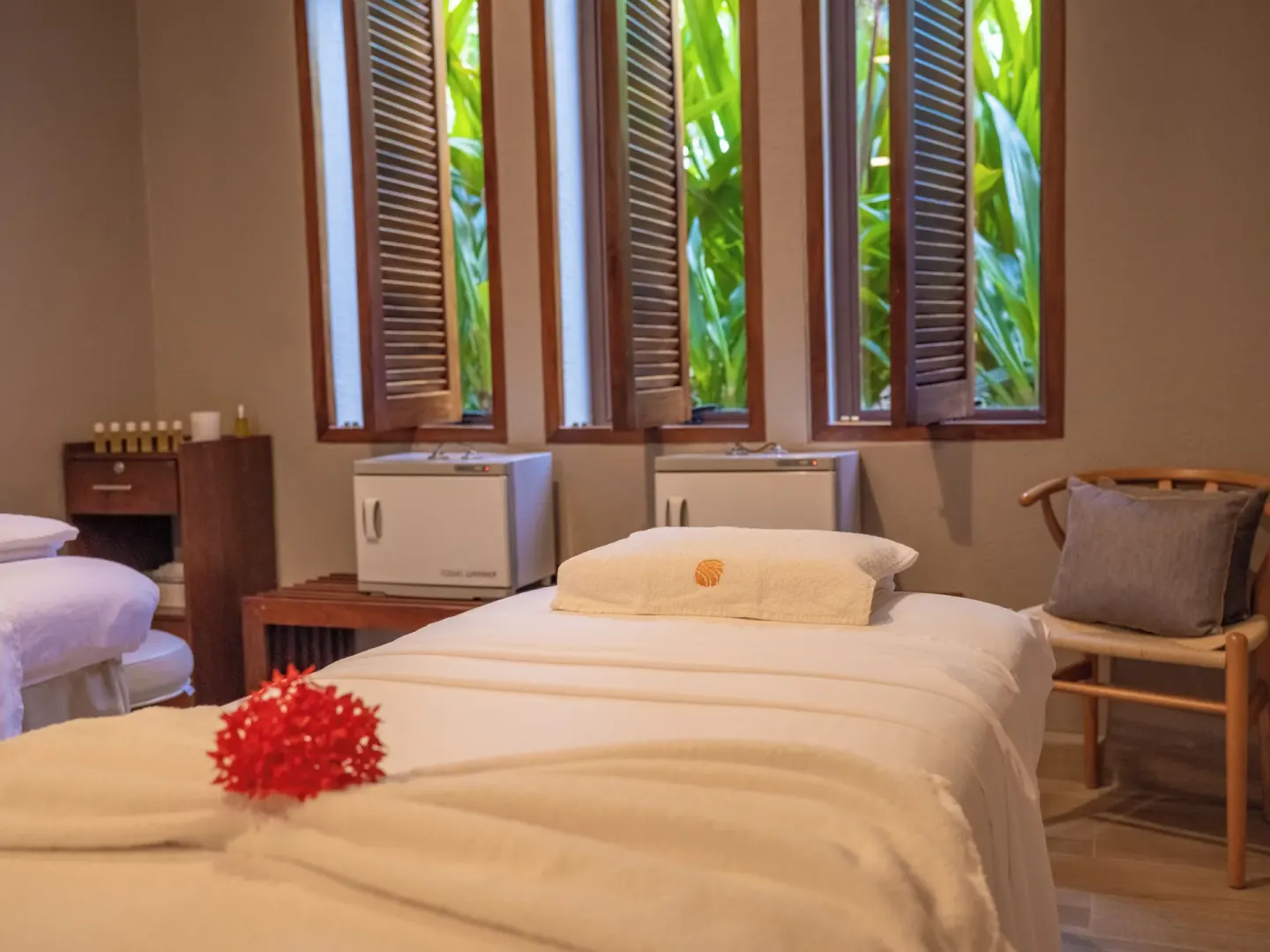 Spa treatment room with massage beds and shuttered windows at Las Brisas Ixtapa.