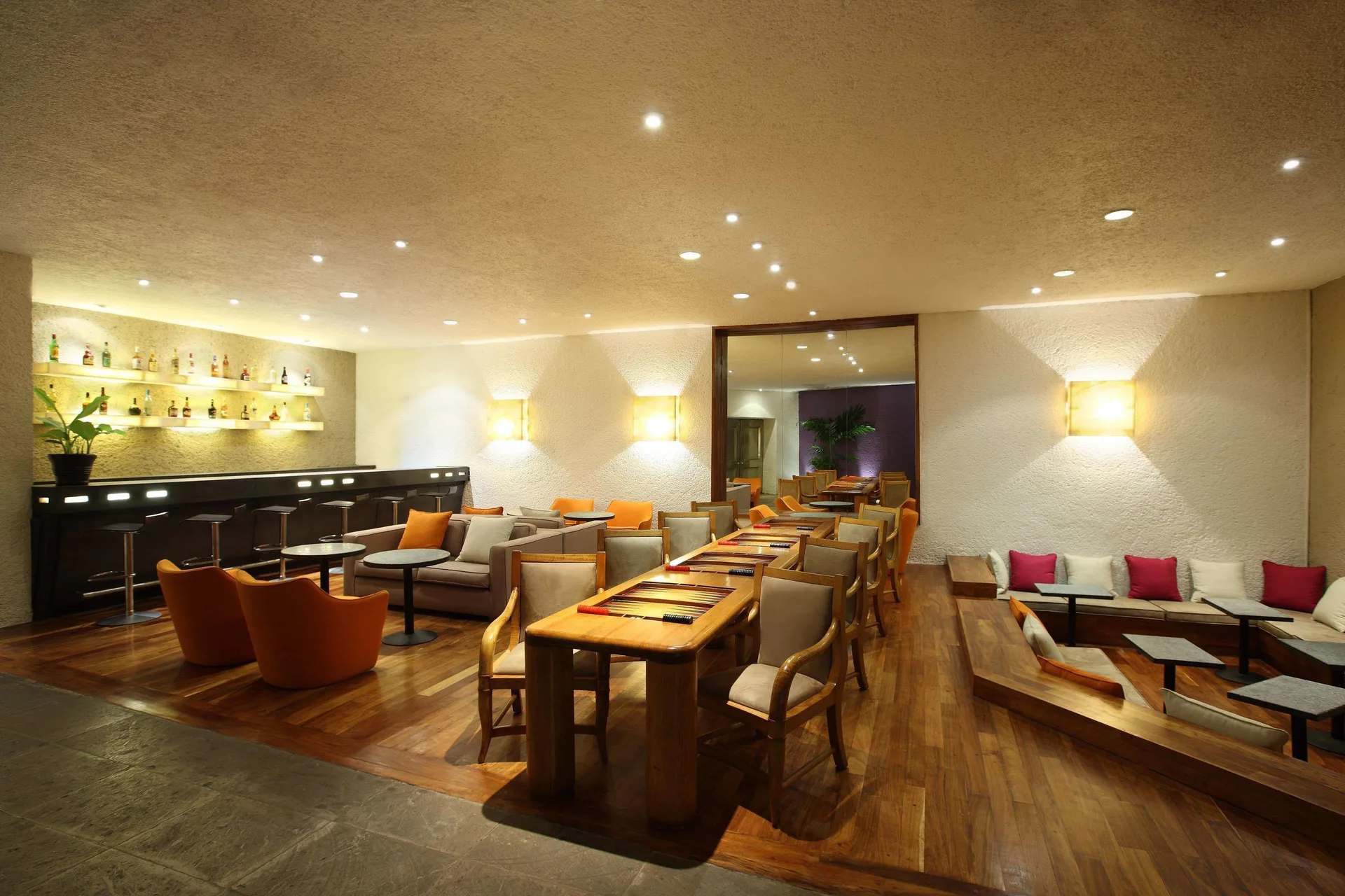 Lobby bar lounge with long table, sofas and bar counter at Las Brisas Ixtapa.