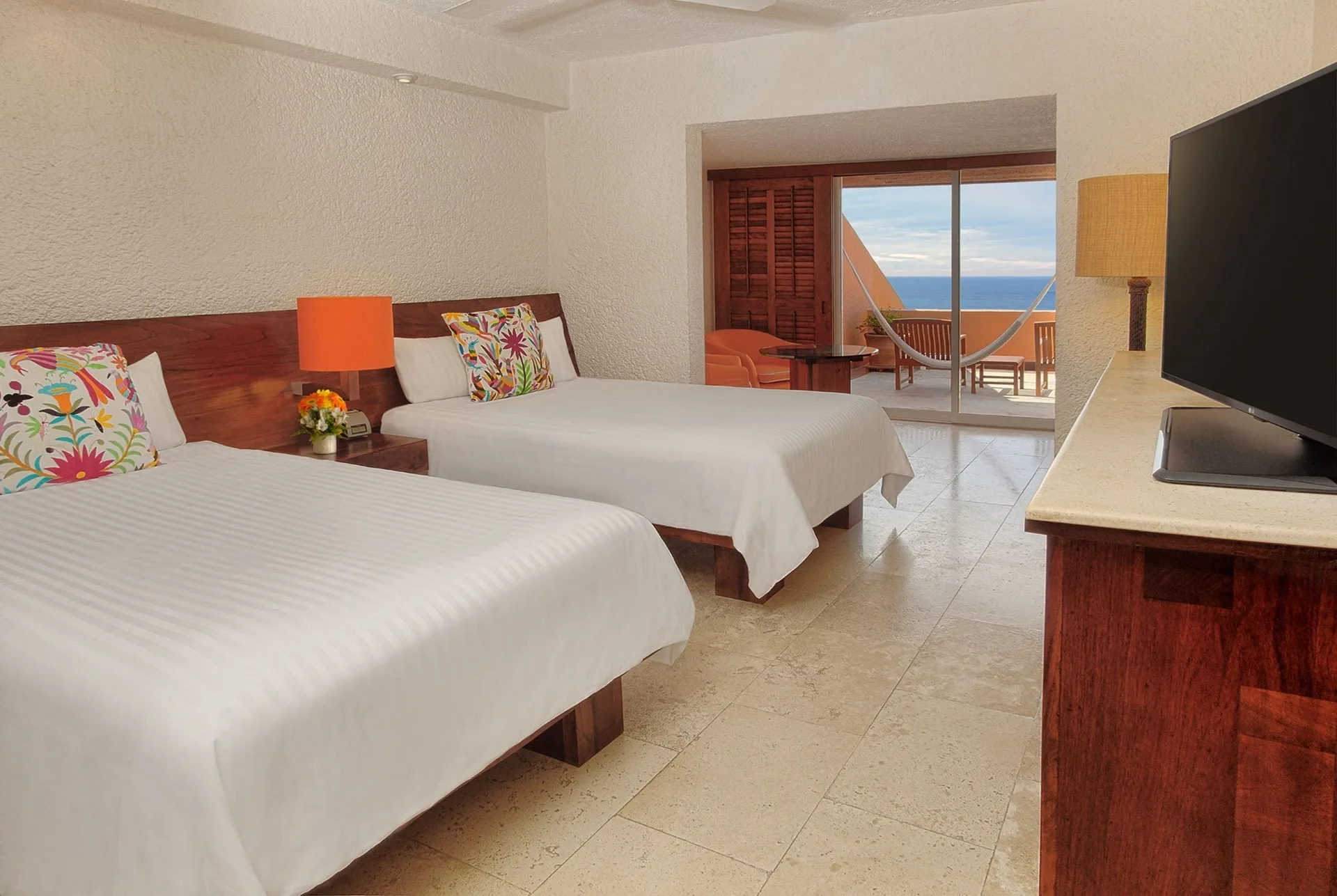 Deluxe Grand room with two beds, balcony, and ocean view at Las Brisas Ixtapa.