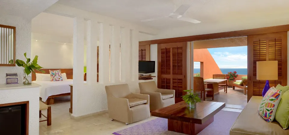 Junior Suite at Las Brisas Ixtapa with living area, king bed, and ocean-view terrace.