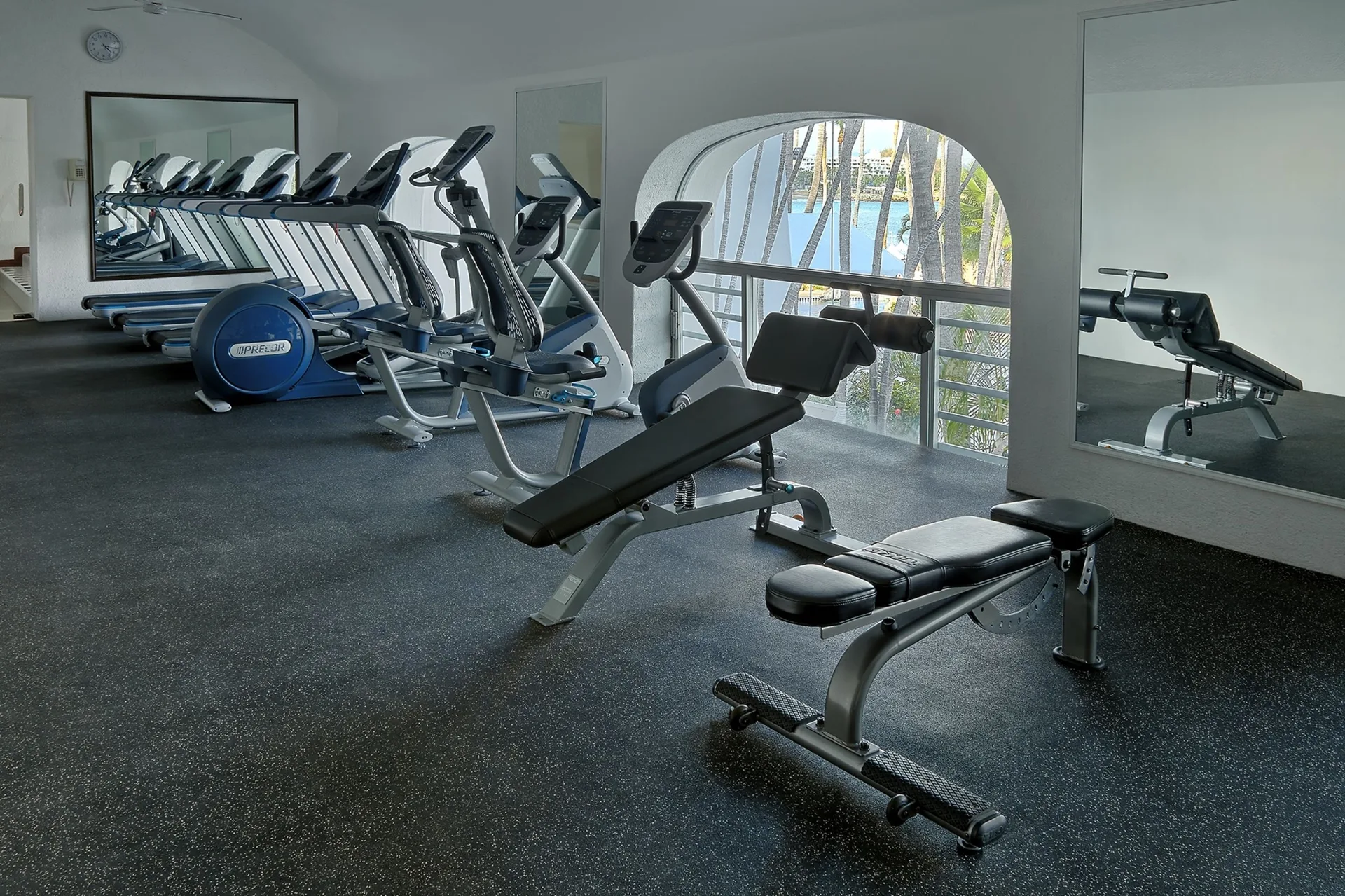 Fitness room with treadmills, cardio machines, and benches at Las Hadas.