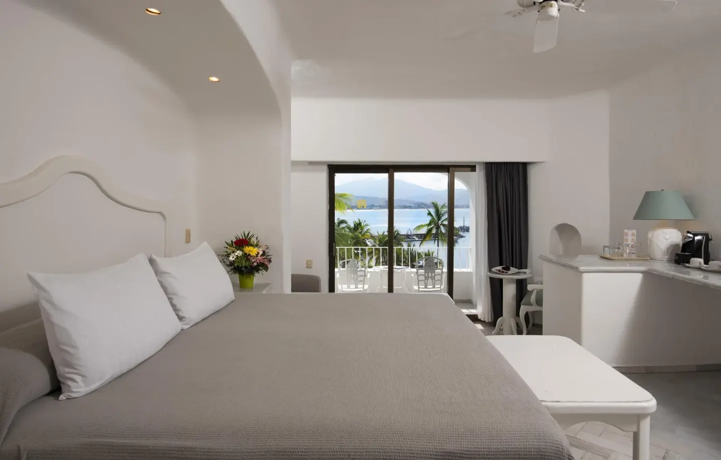 King bed guest room with balcony and bay view at Las Hadas.