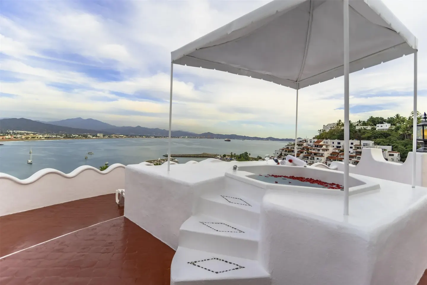 Private terrace with canopy tub and bay panorama at Las Hadas.