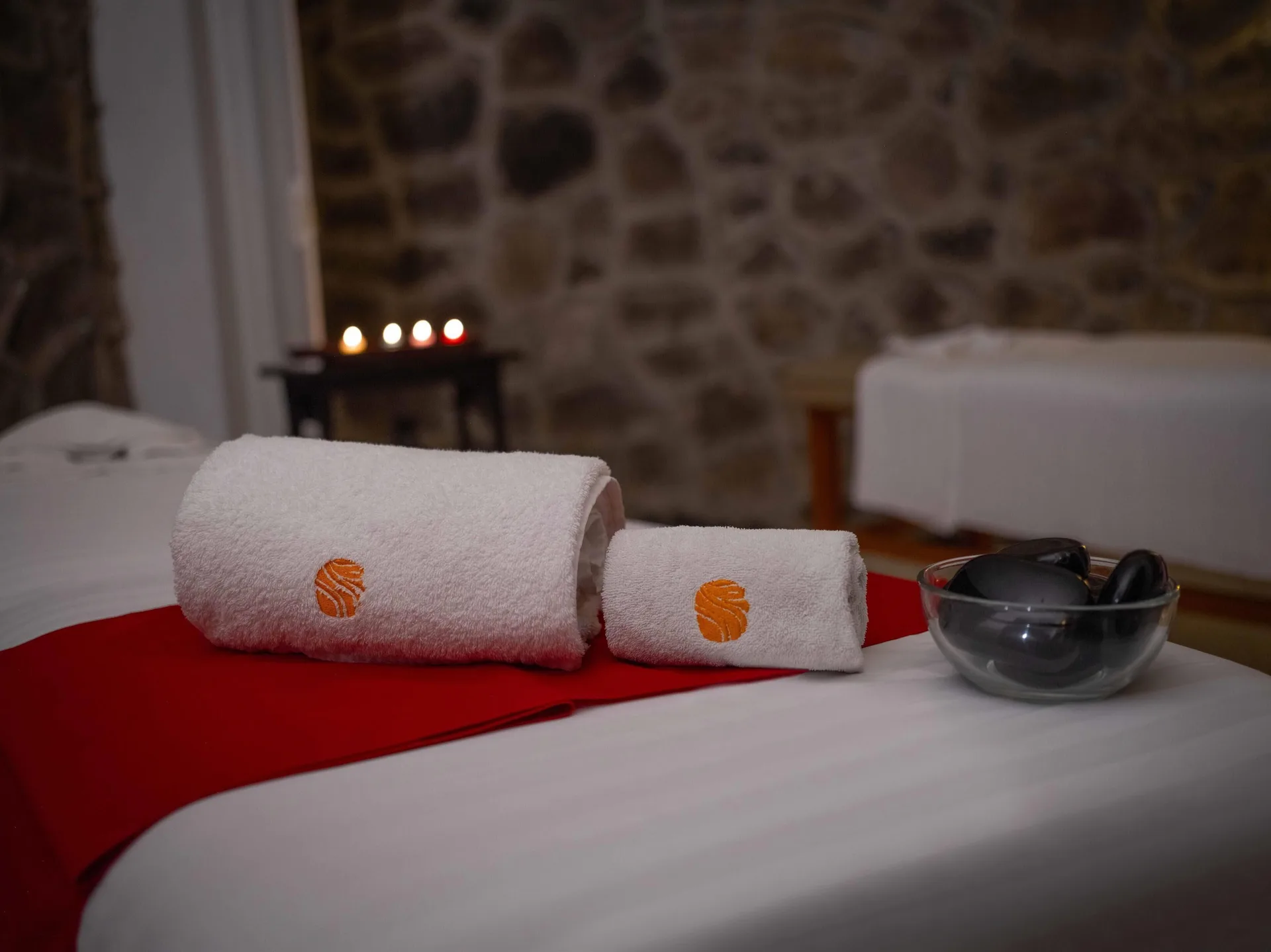 Rolled towels on a spa treatment table with candles at Las Hadas.