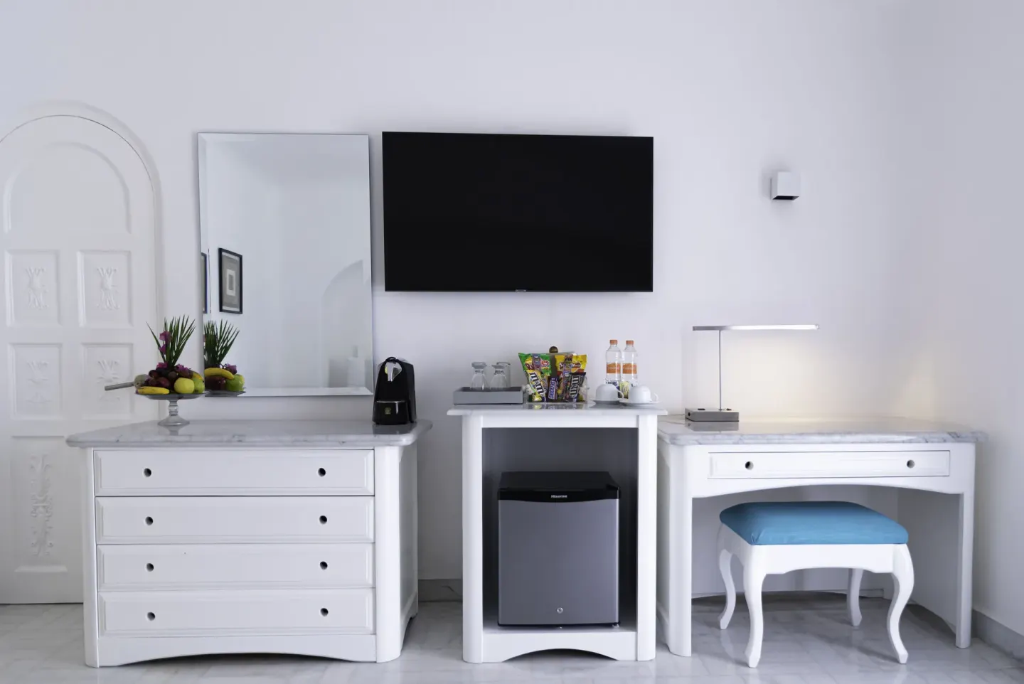 Deluxe Room media wall with dresser, desk, TV and minibar at Las Hadas.