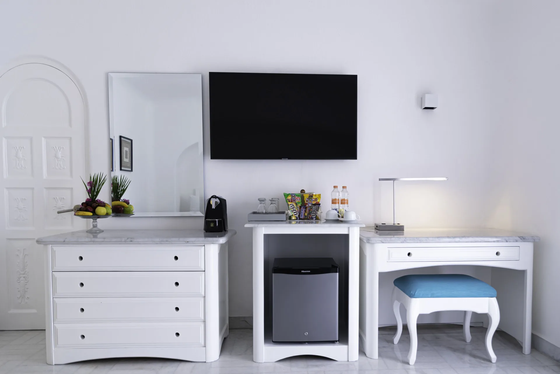 Deluxe Room media wall with dresser, desk, TV and minibar at Las Hadas.