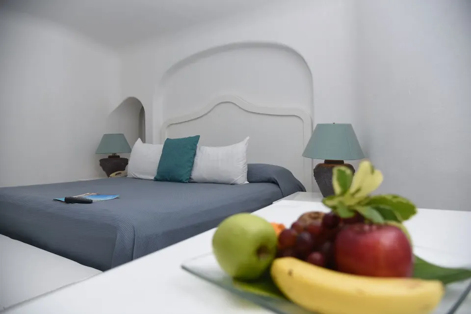 Fantasy Suite king bed with fruit tray in the foreground at Las Hadas.