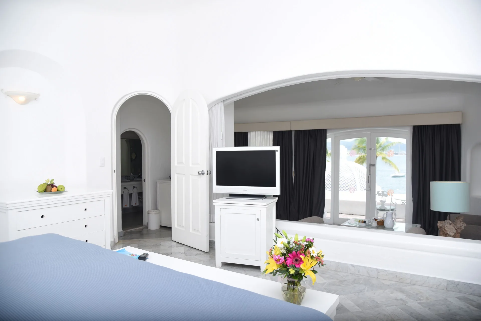 Fantasy Suite bedroom with TV and terrace doors at Las Hadas.