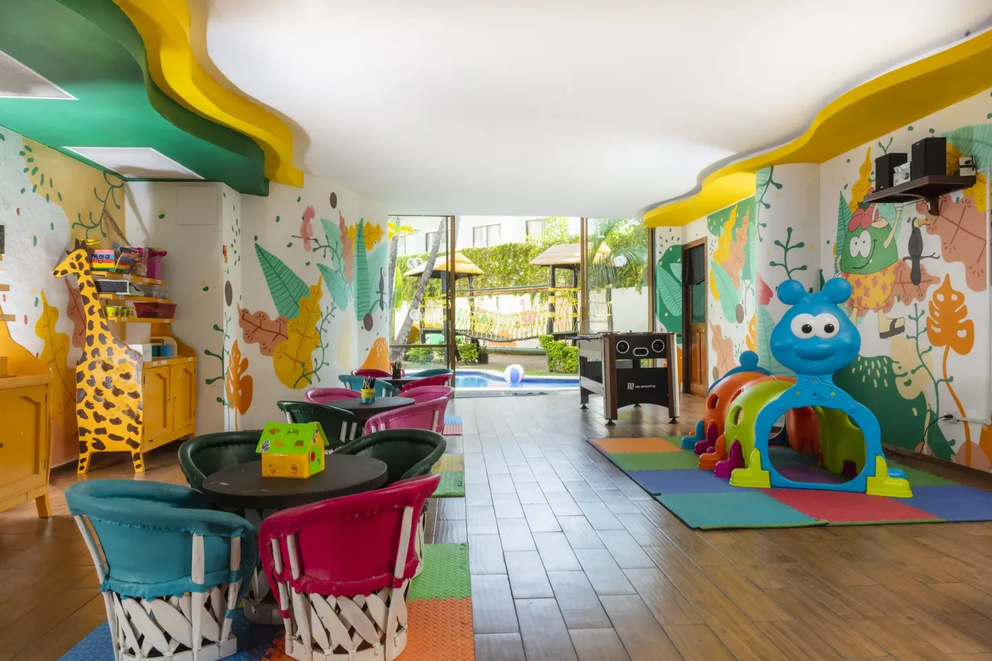 Kids club seating, murals, foosball, and soft play area at Las Palmas by the Sea.