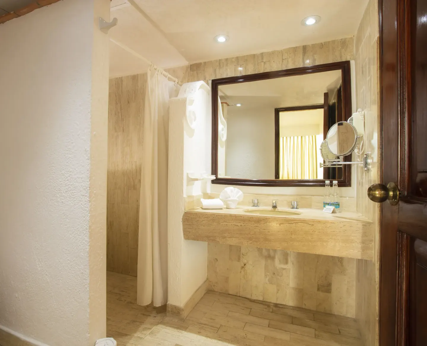 Ocean Front bathroom with stone vanity and shower curtain at Las Palmas by the Sea.