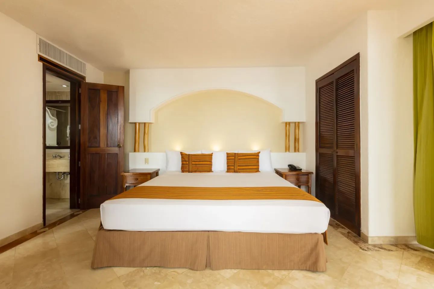Ocean Front room king bed with open bathroom doorway at Las Palmas by the Sea.