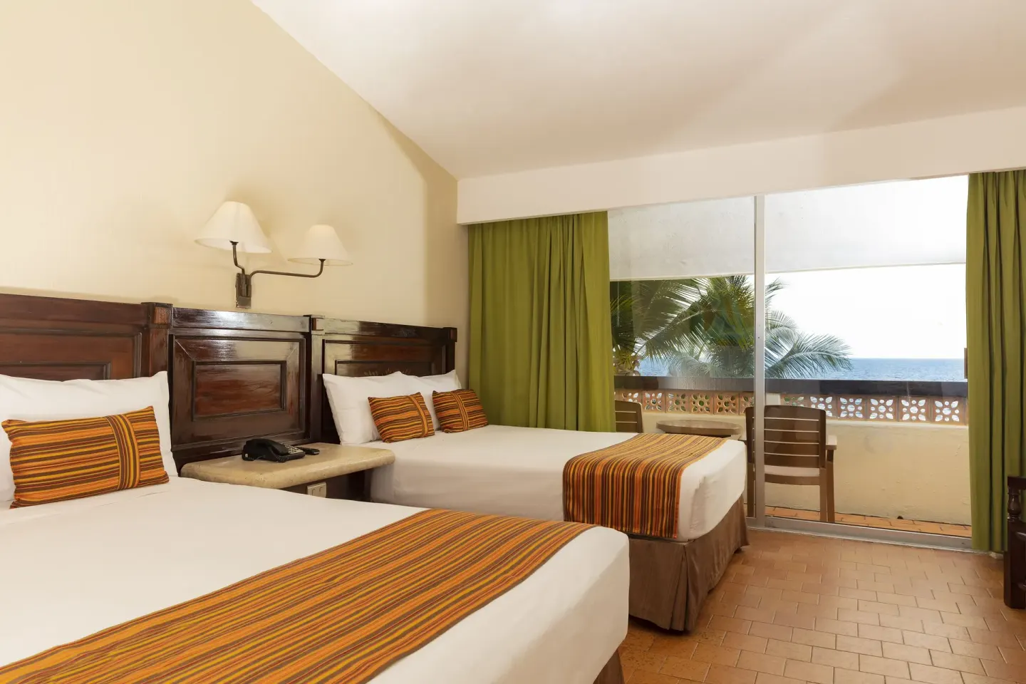 Ocean View Room with two beds, balcony, palm trees and sea at Las Palmas by the Sea.
