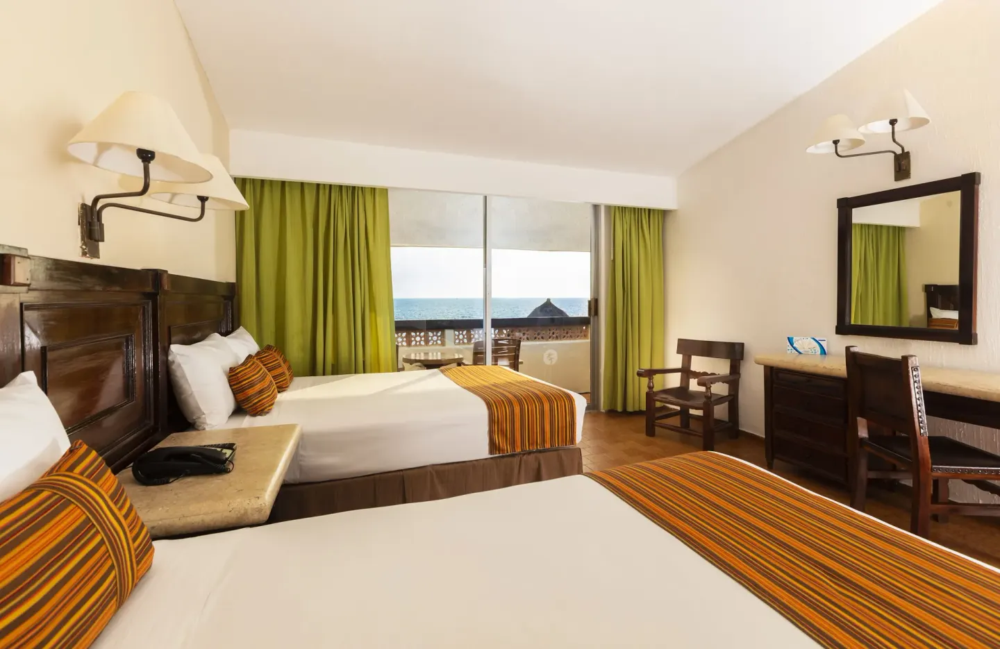 Ocean View Room with two beds, desk, mirror and sea-facing balcony at Las Palmas by the Sea.