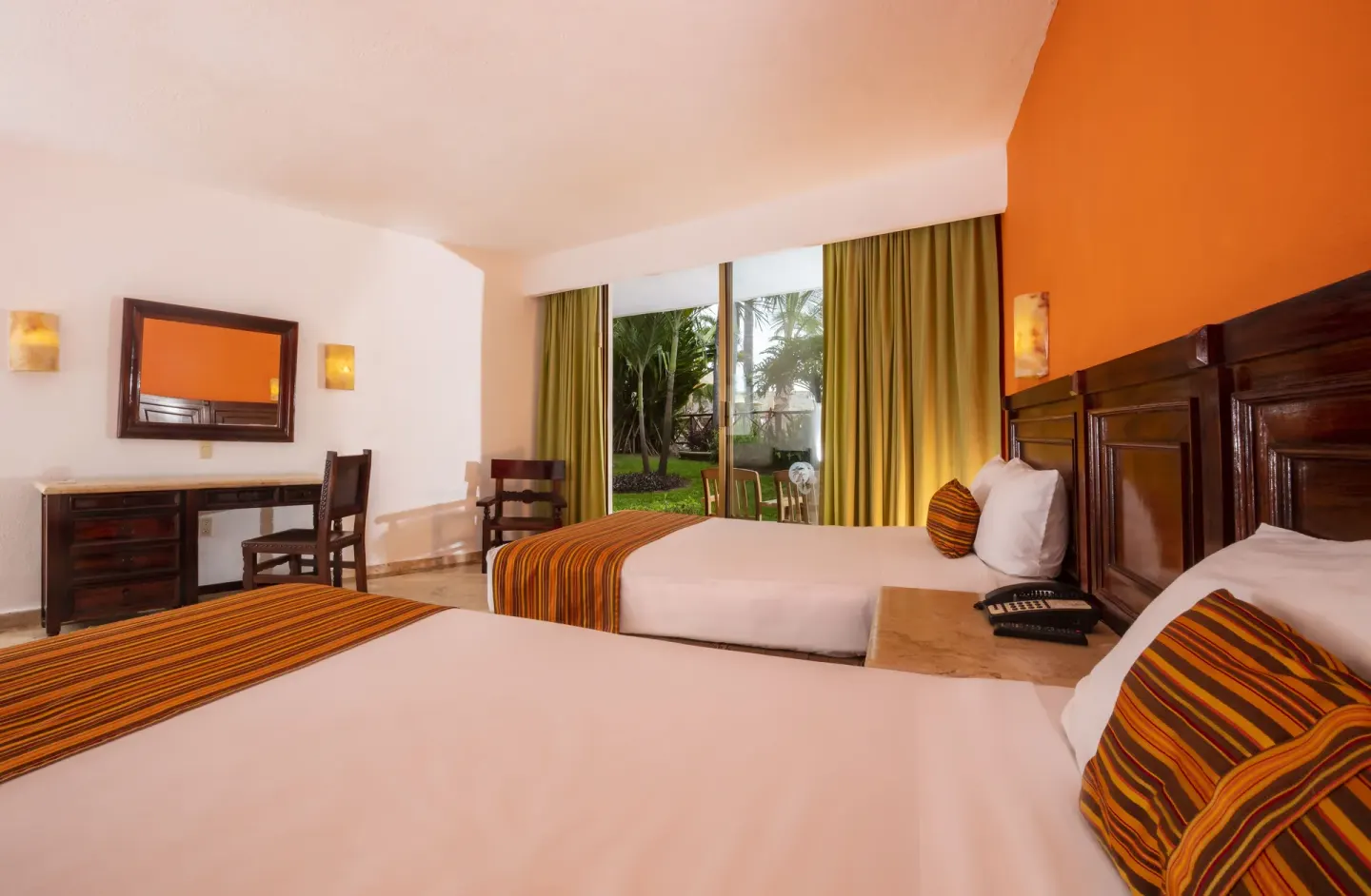 Standard terrace room with two double beds and garden-facing glass doors at Las Palmas by the Sea.