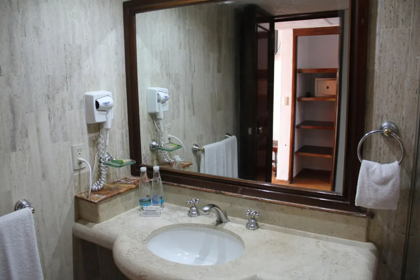 Standard Room bathroom vanity with mirror and sink at Las Palmas by the Sea.