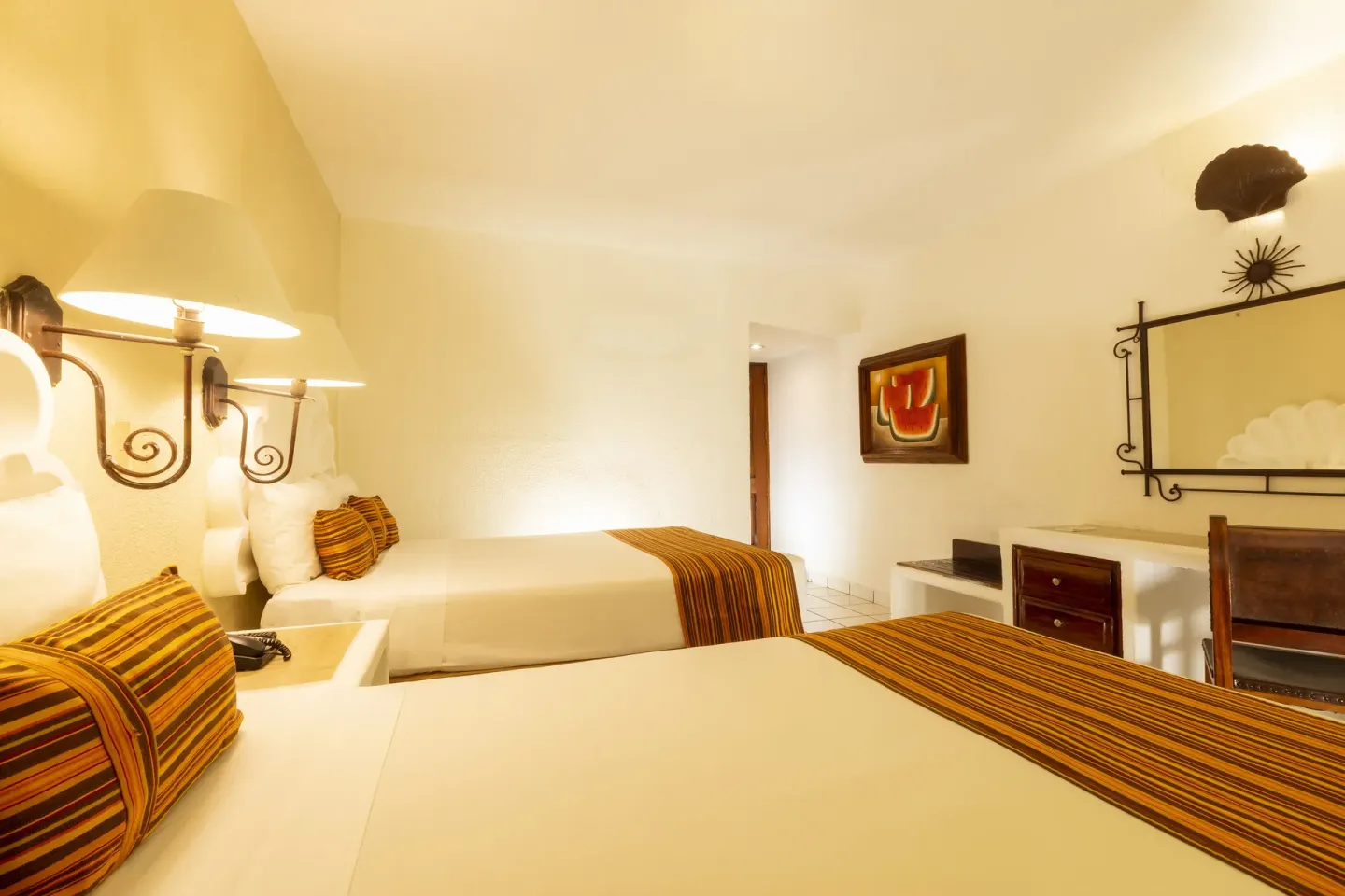 Standard Room with two beds, shell headboards, lamps, and desk at Las Palmas by the Sea.