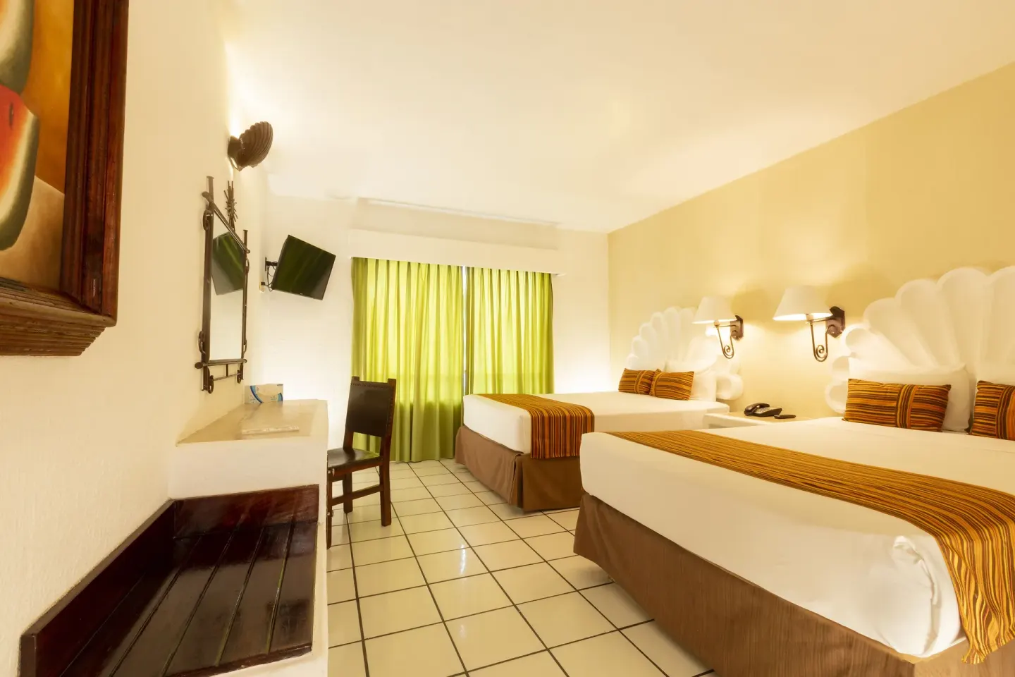 Standard Room with two beds, tiled floor, desk, mirror, TV, and green curtains at Las Palmas by the Sea.