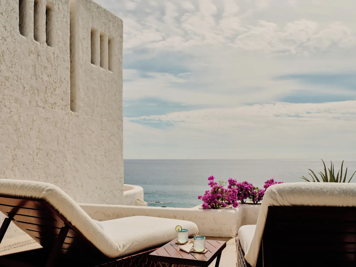 Terrace loungers with drinks and ocean view at Las Ventanas al Paraiso.