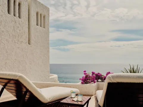 Terrace loungers with drinks and ocean view at Las Ventanas al Paraiso.