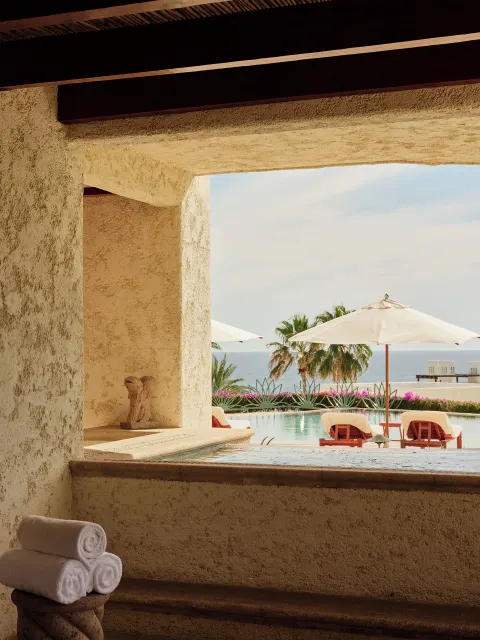 Plunge pool ledge with towels and resort pool view at Las Ventanas al Paraiso.