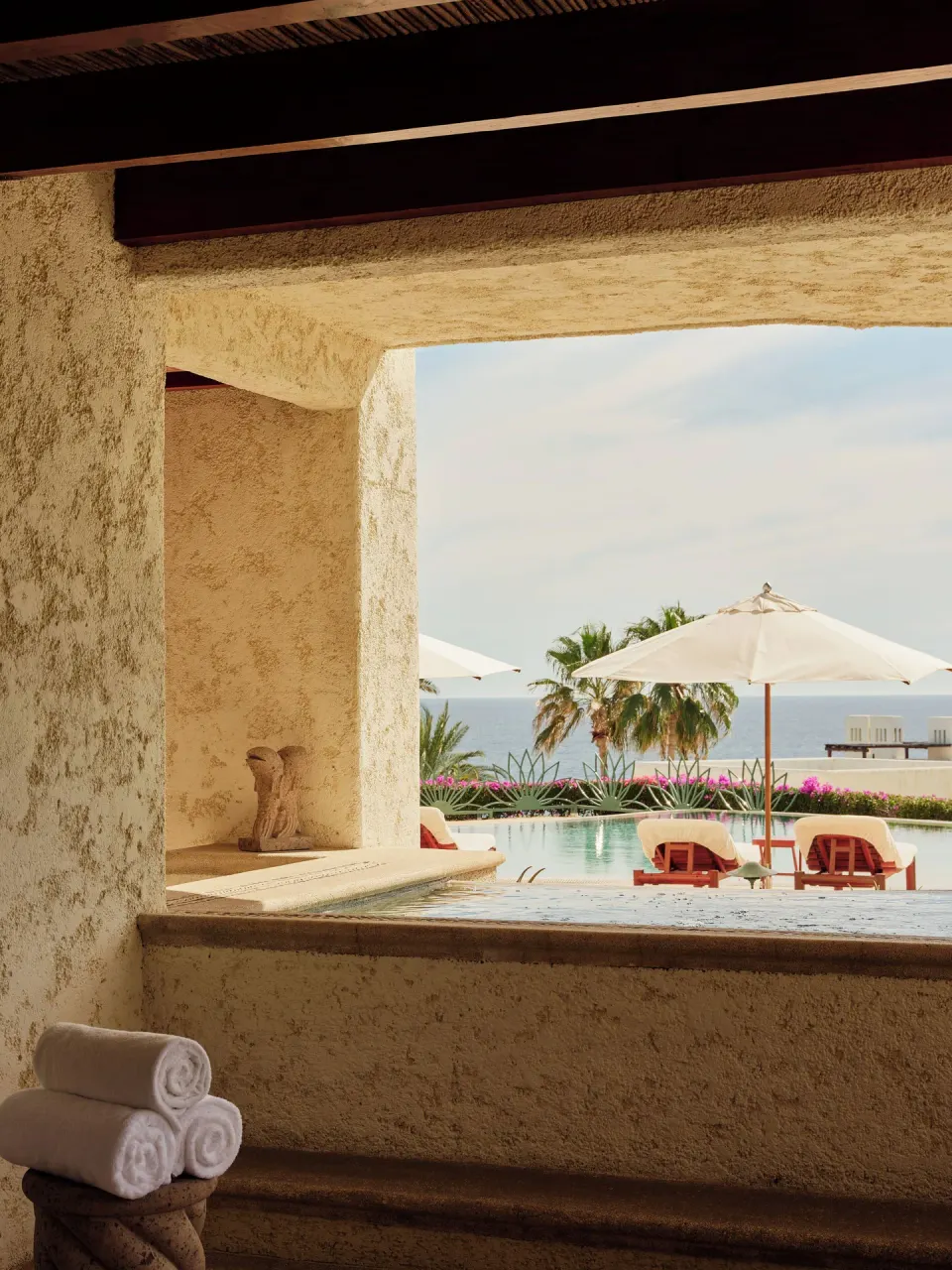 Plunge pool ledge with towels and resort pool view at Las Ventanas al Paraiso.