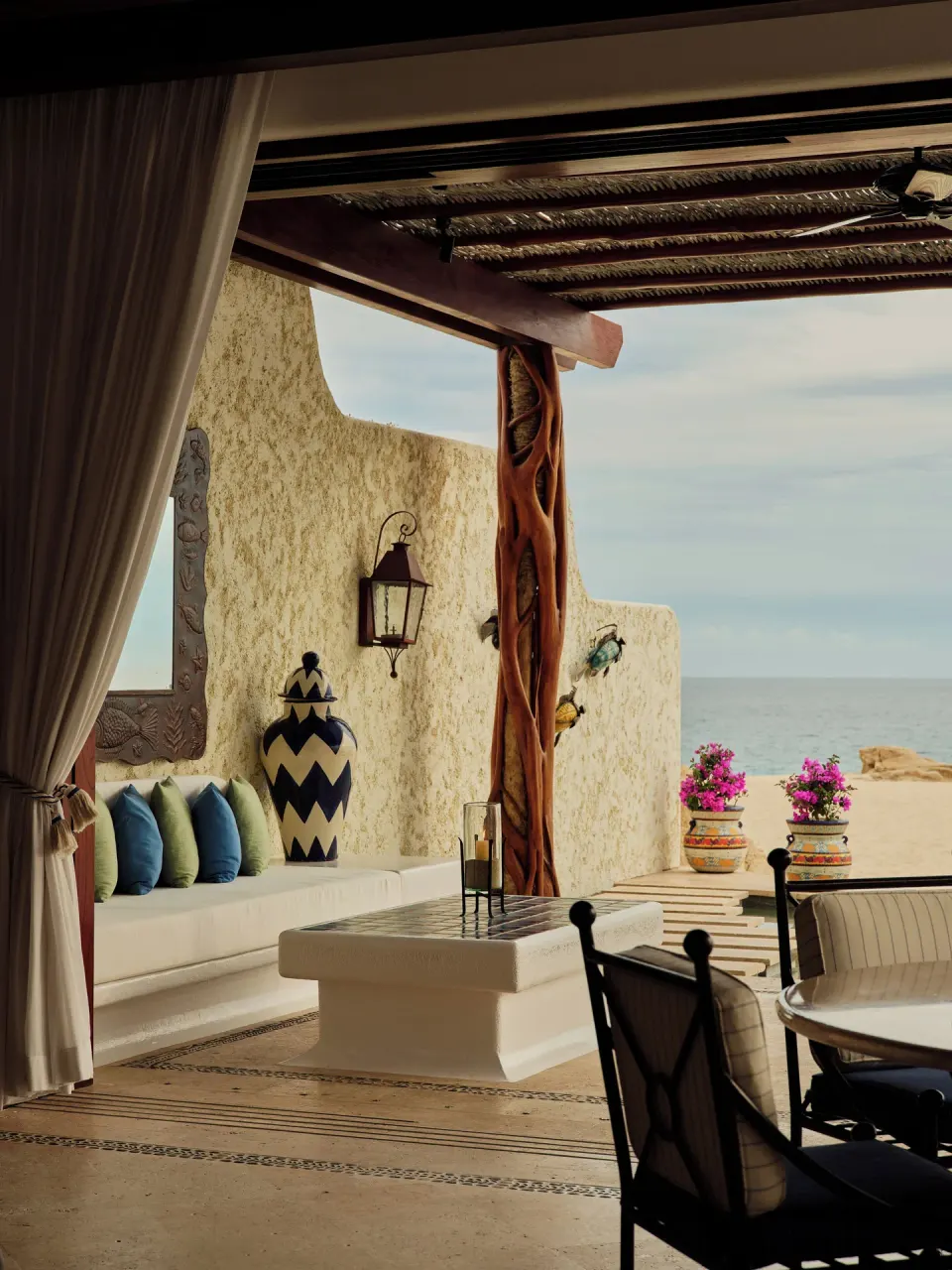 Covered beachfront terrace with seating and ocean view at Las Ventanas al Paraiso.