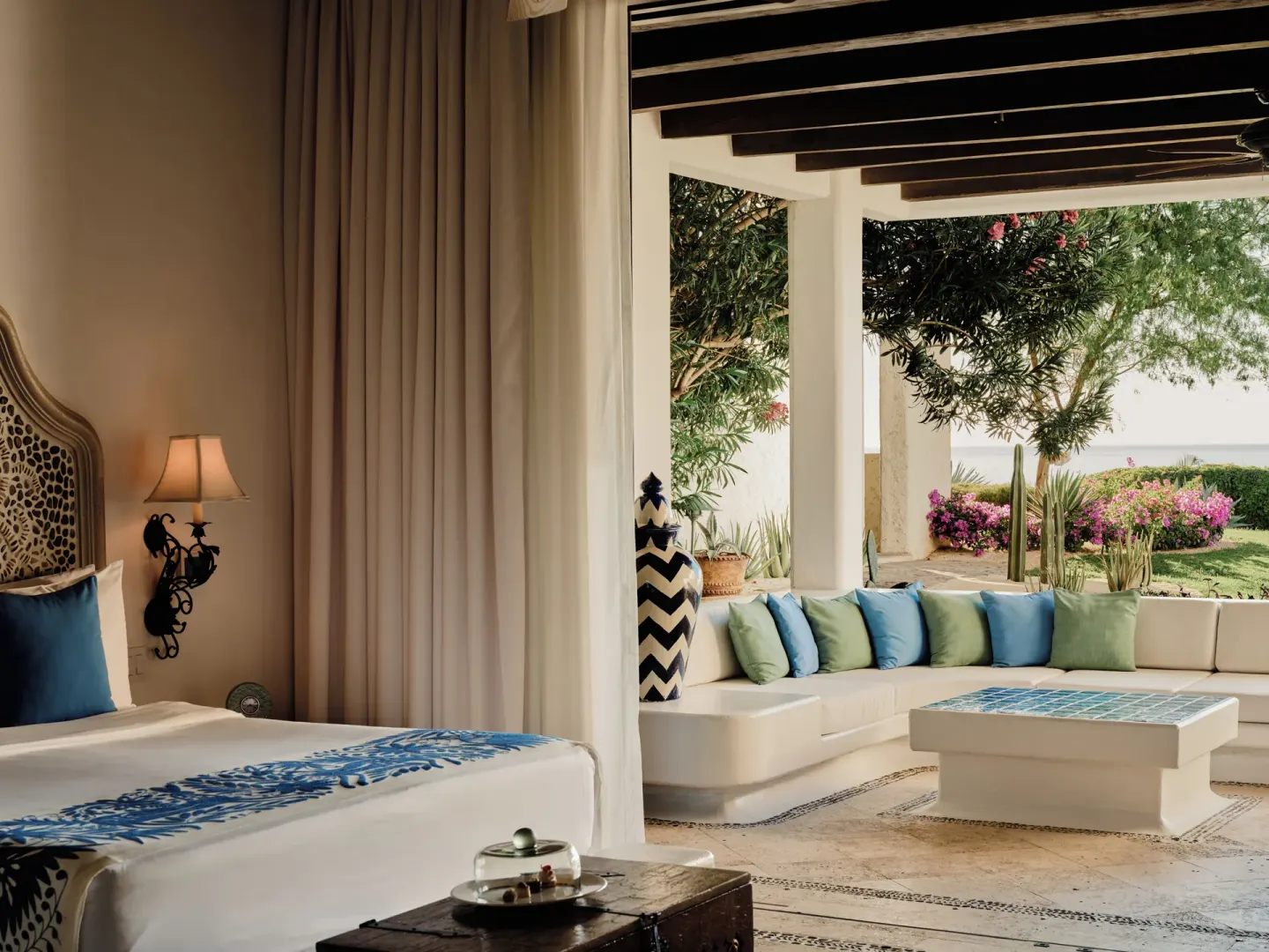 Gardenview Junior Suite bed opening to a shaded garden terrace at Las Ventanas al Paraiso.