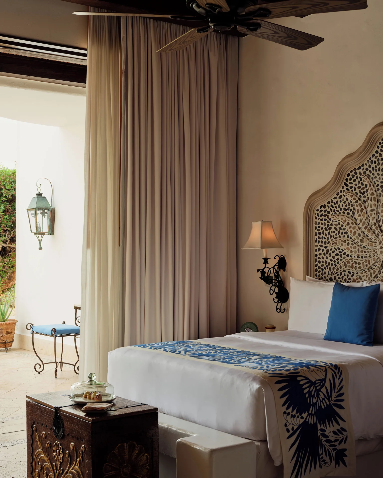 Gardenview Junior Suite bed and terrace doorway at Las Ventanas al Paraiso.