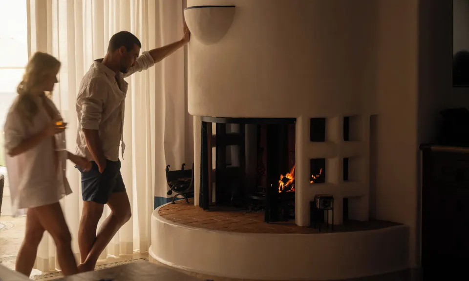 Ocean Front Junior Suite fireplace with guests nearby at Las Ventanas al Paraiso.