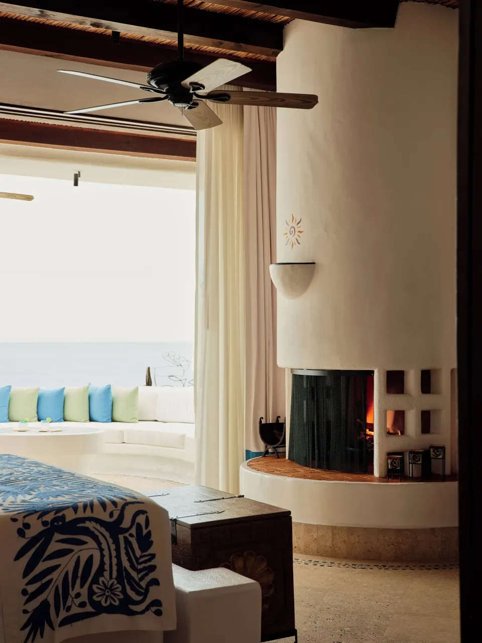 Ocean Front Junior Suite king bed and rounded fireplace at Las Ventanas al Paraiso.