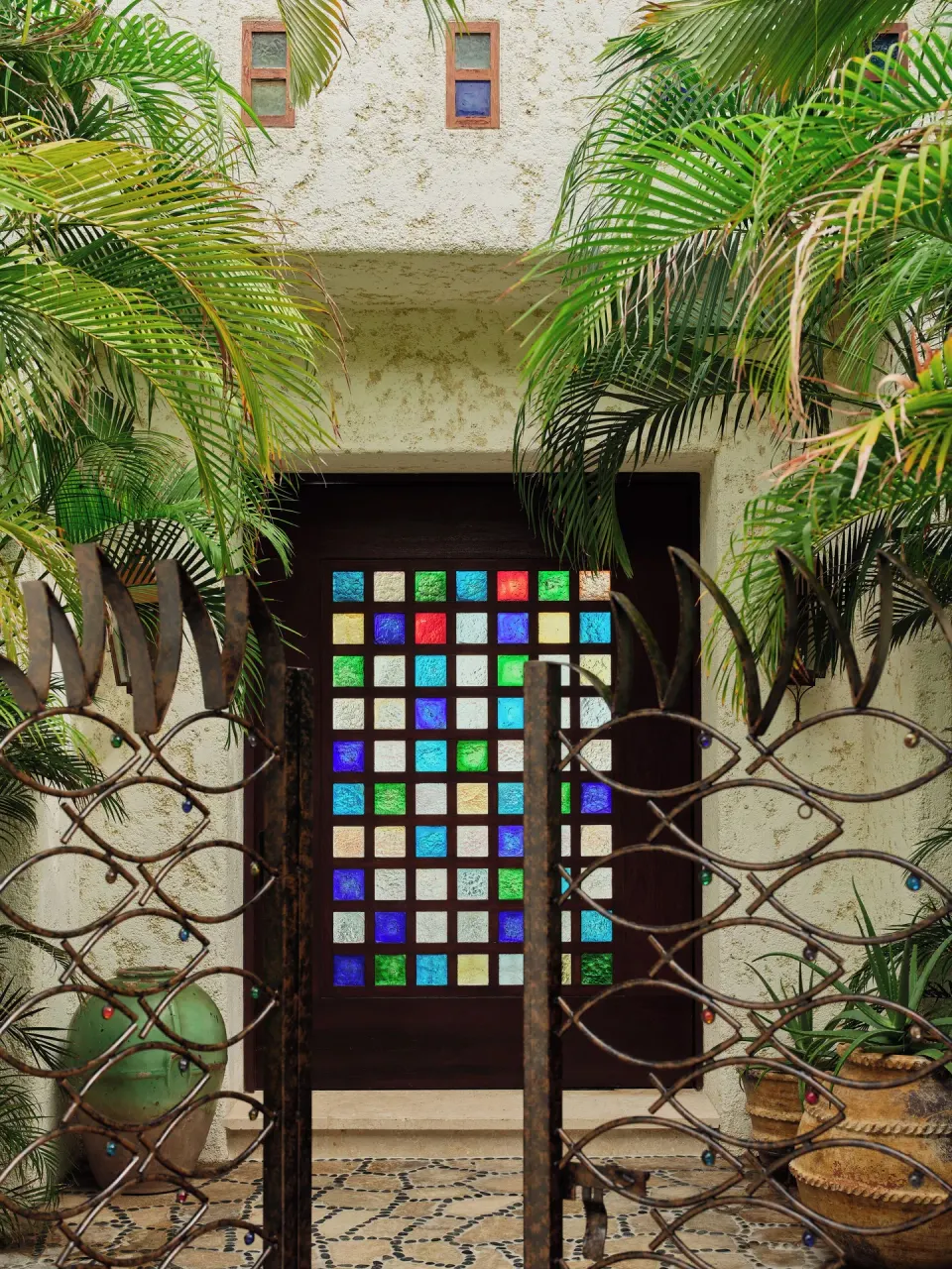 Villa entry gate with colorful glass door panels at Las Ventanas al Paraiso.