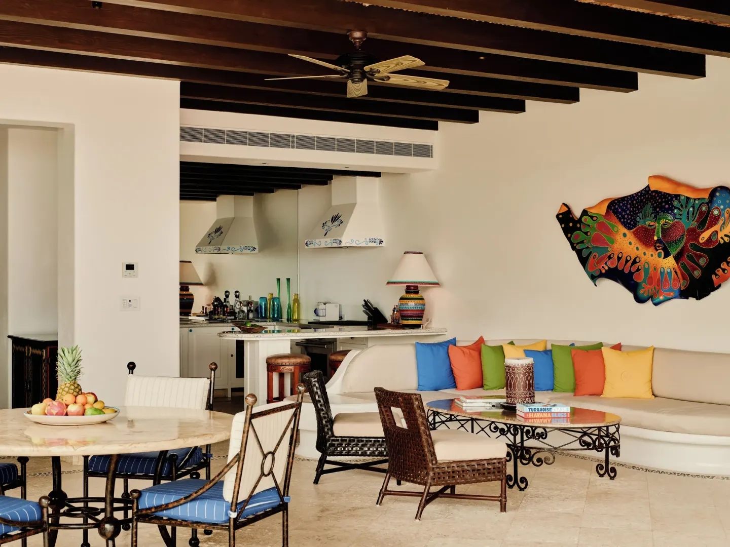 Open villa living and dining area with colorful sofa pillows at Las Ventanas al Paraiso.