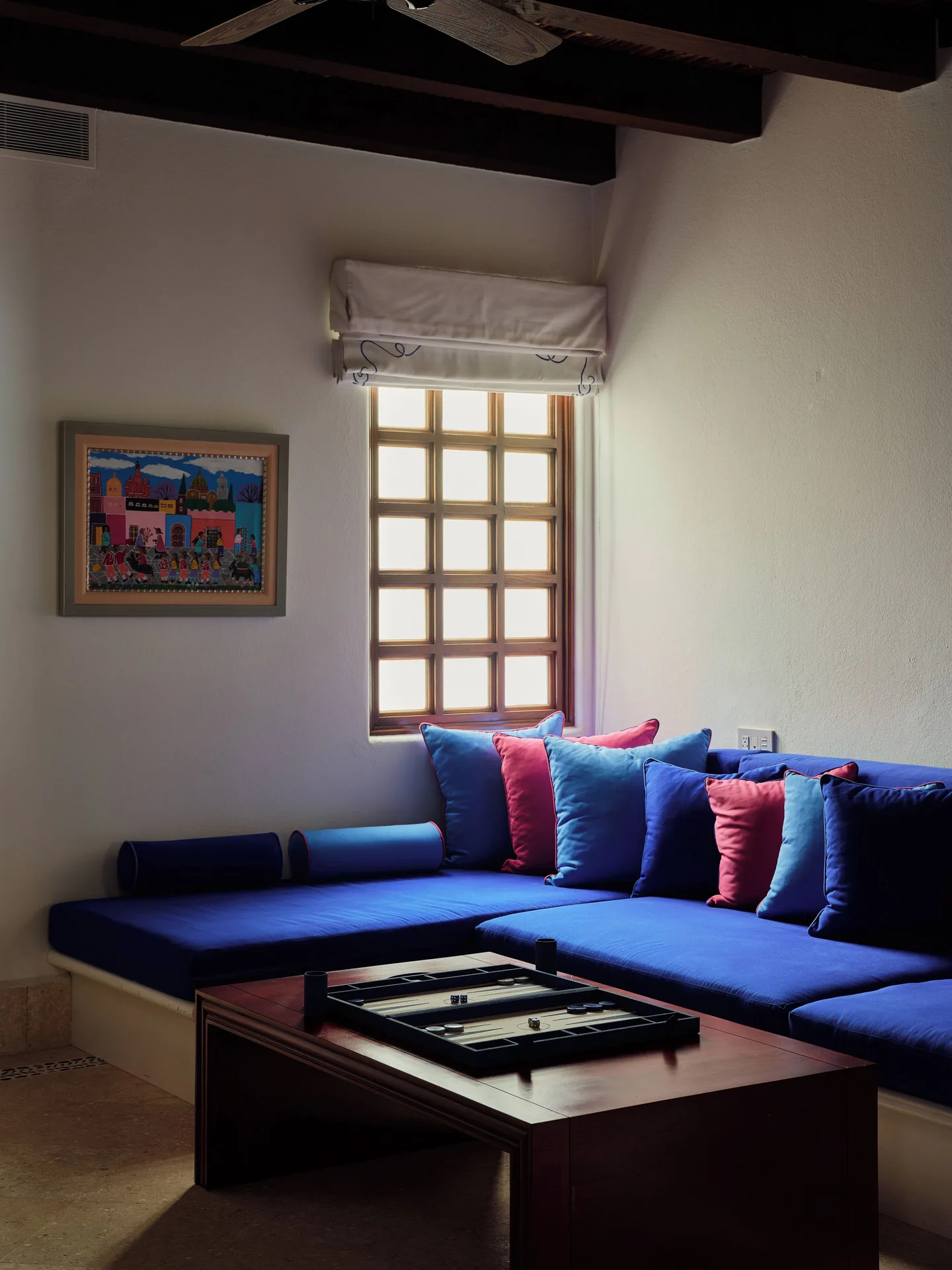 Window-side blue sectional lounge in a villa living room at Las Ventanas al Paraiso.