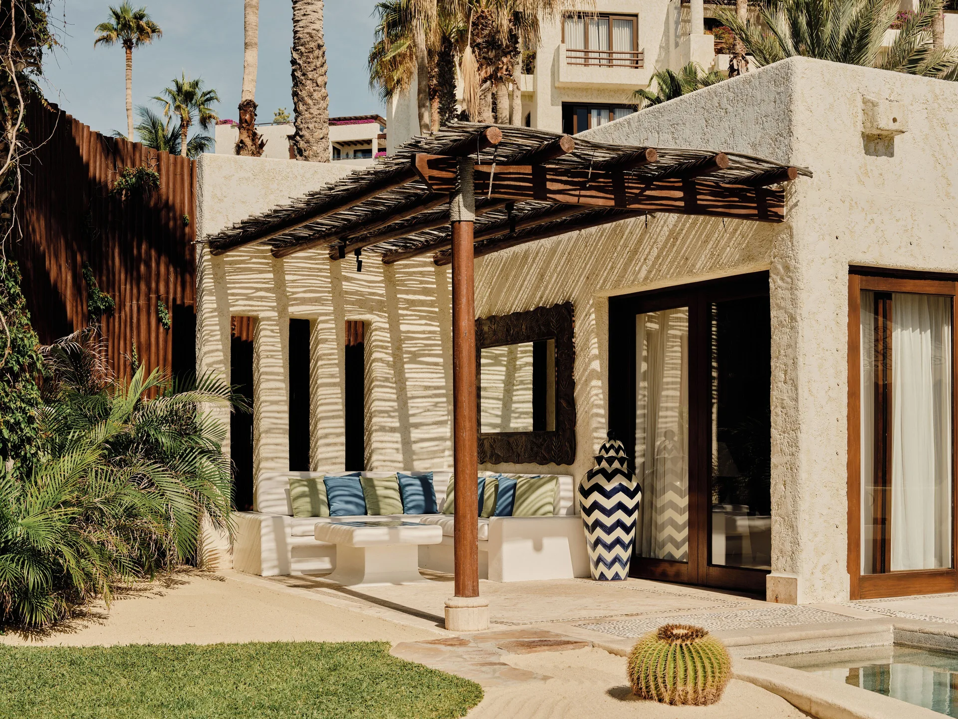 Exterior terrace of a One Bedroom Oceanfront Villa at Las Ventanas al Paraiso with shaded seating and pool.