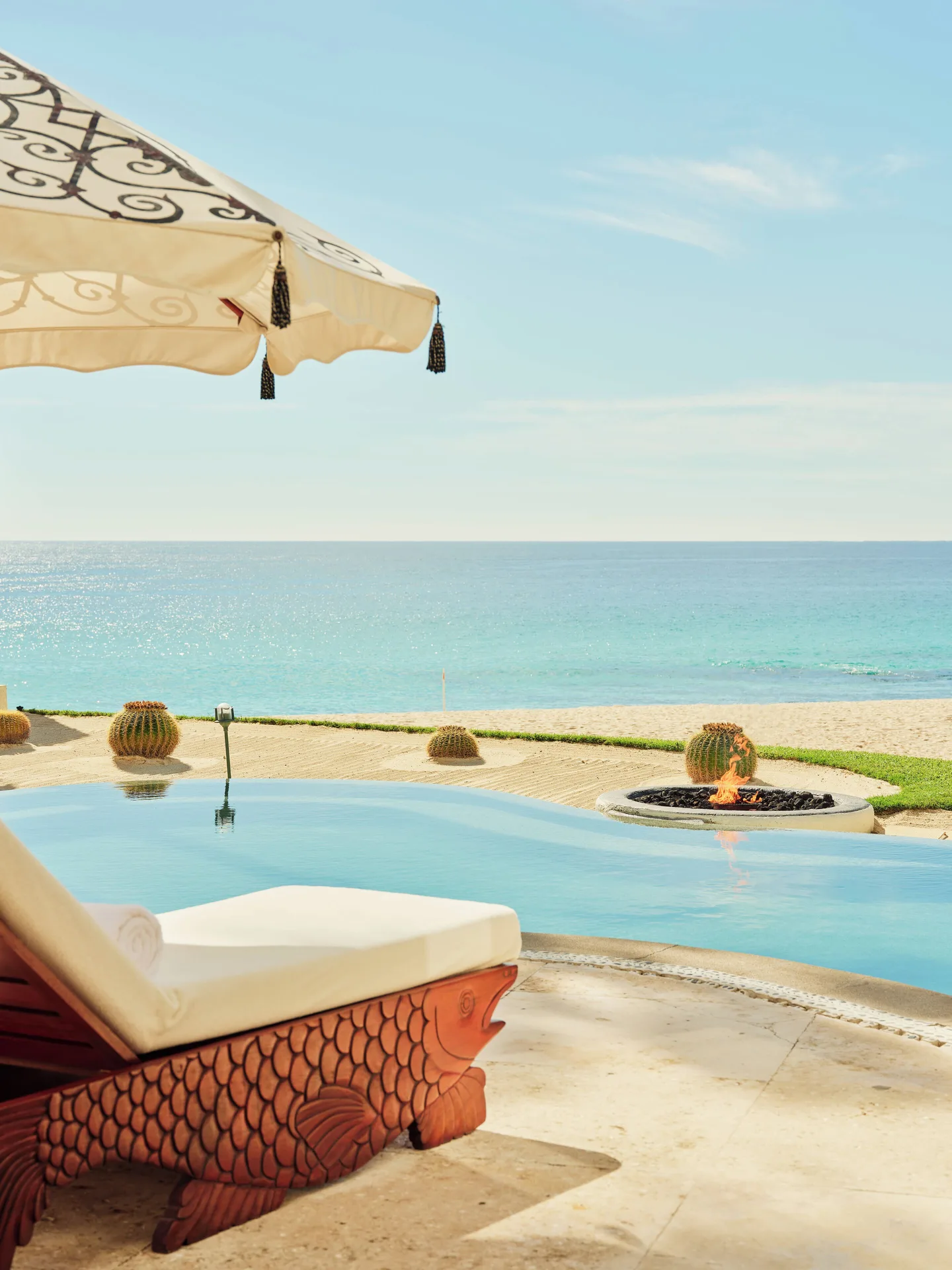Oceanfront pool of a One Bedroom Oceanfront Villa at Las Ventanas al Paraiso with lounger and fire bowl.