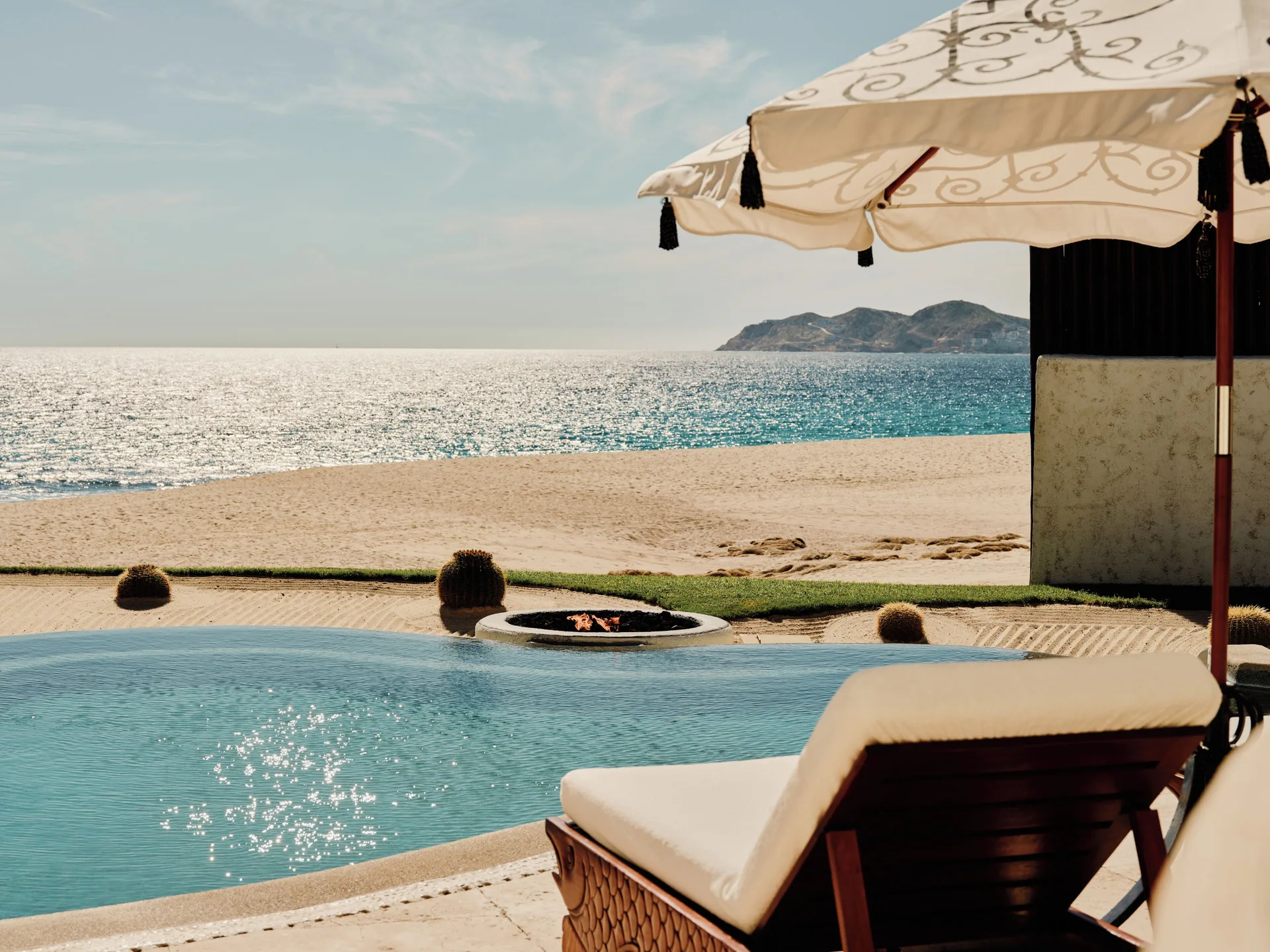 Ocean view from a One Bedroom Oceanfront Villa pool terrace at Las Ventanas al Paraiso with umbrella.