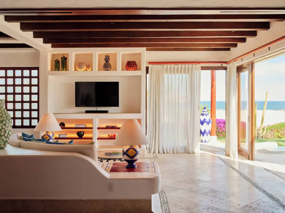 One Bedroom Oceanview Villa living room with ocean-facing glass doors at Las Ventanas al Paraiso.