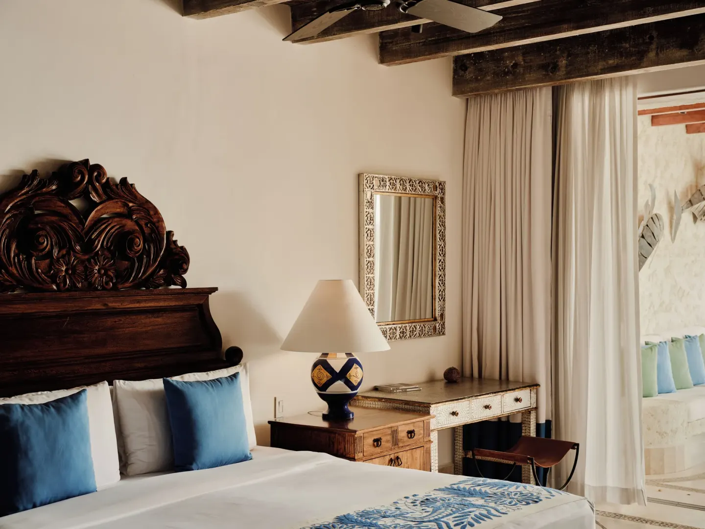 Three Bedroom Oceanview Residence bedroom with carved headboard at Las Ventanas al Paraiso.