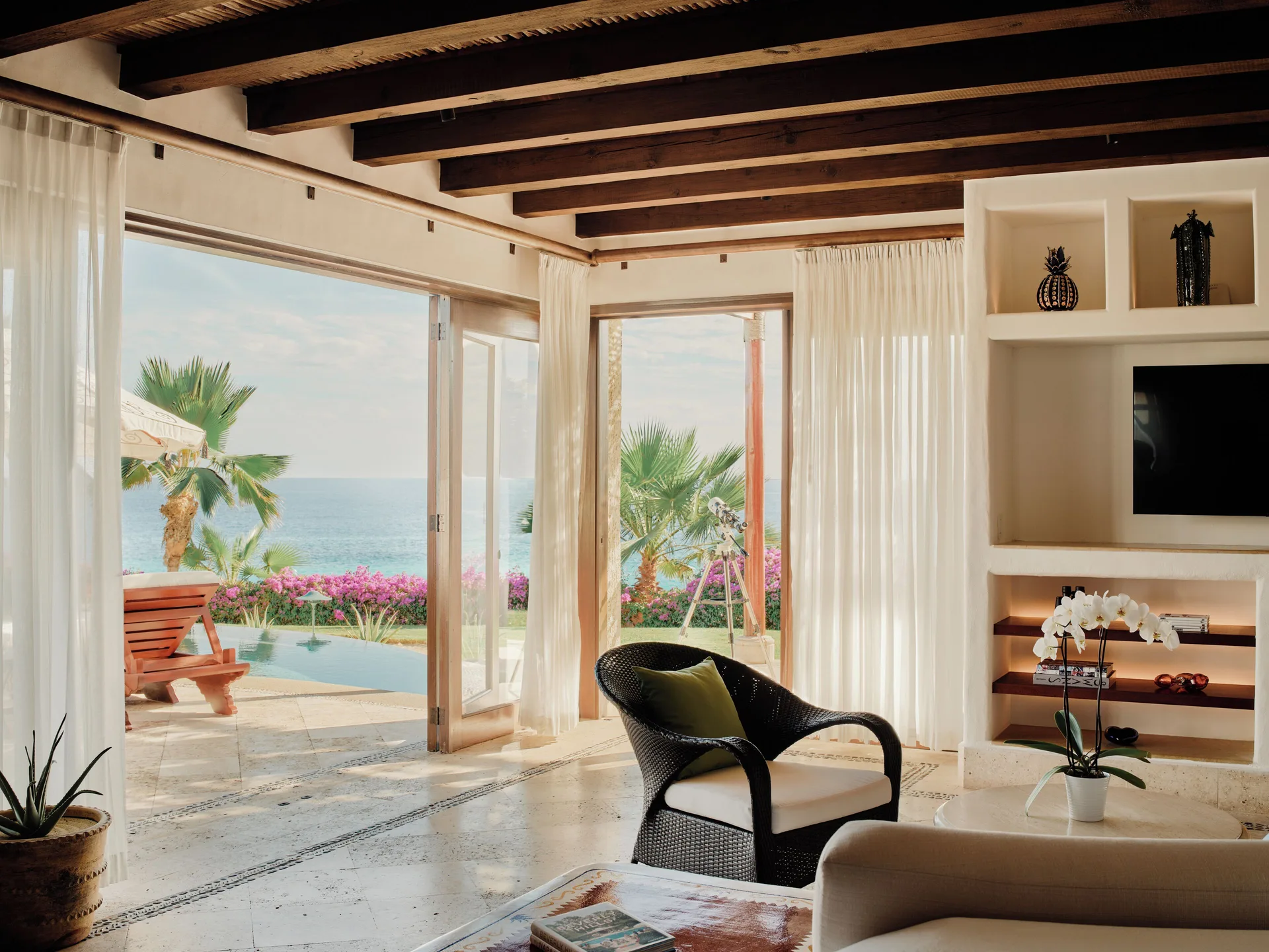 Living room in the Three Bedroom Oceanview Villa at Las Ventanas al Paraiso with ocean-facing doors.