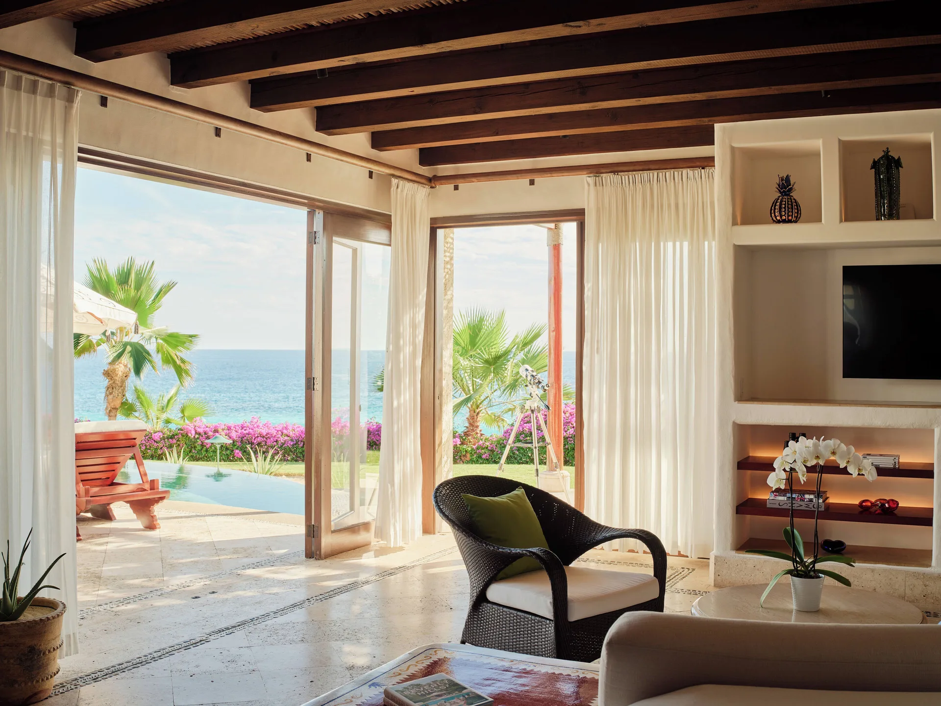 Three Bedroom Oceanview Villa living room at Las Ventanas al Paraiso opening to pool and ocean views.