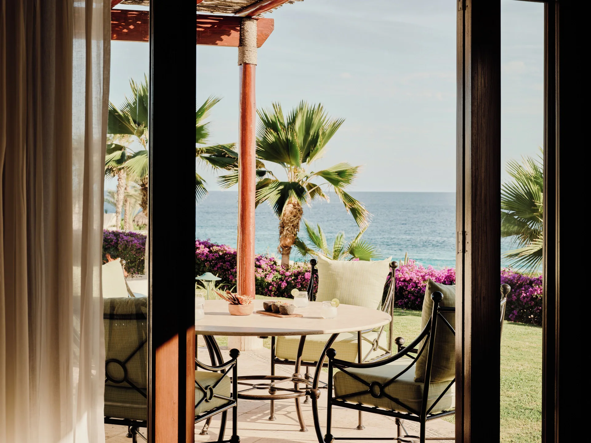 Three Bedroom Oceanview Villa patio at Las Ventanas al Paraiso seen through doors with ocean beyond.