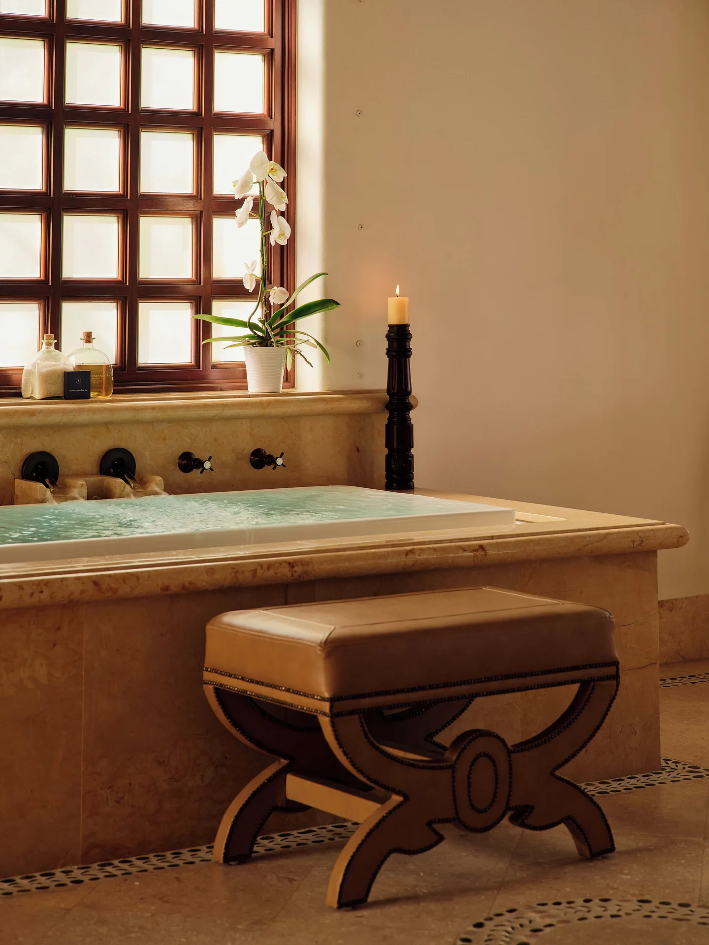 Jetted bath with orchid and candle in a residence bathroom at Las Ventanas al Paraiso.