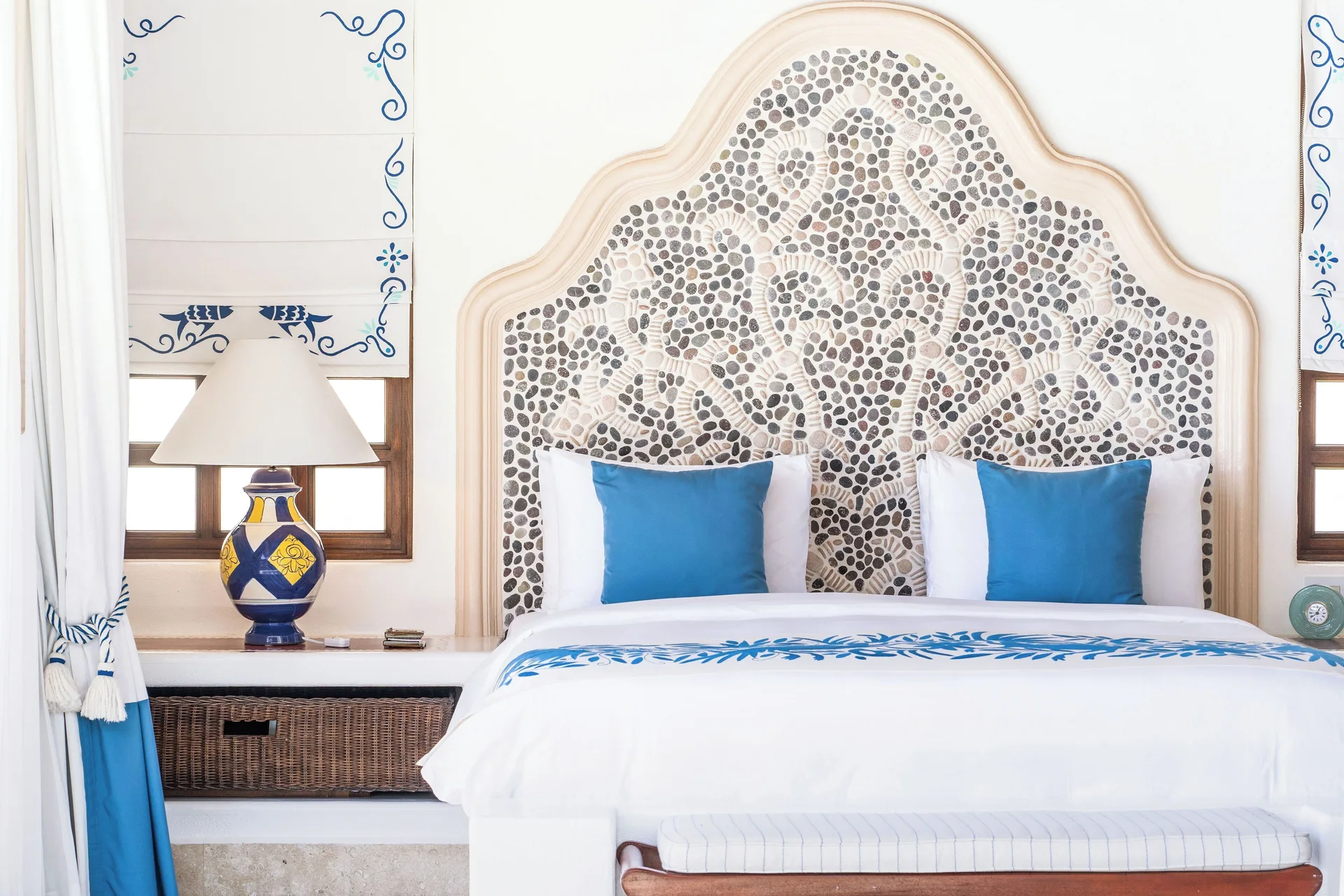 King bed with mosaic headboard in a residence bedroom at Las Ventanas al Paraiso.