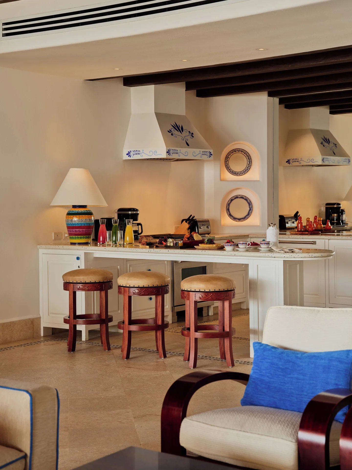Kitchen bar with stools and colorful accents in the residence at Las Ventanas al Paraiso.